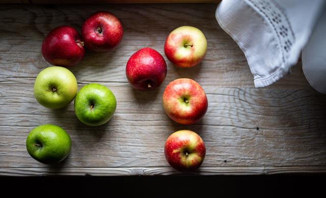 Nine different South Tyrolean apples on a wooden windowsill.