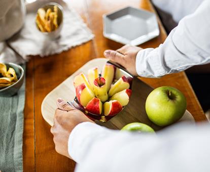 A fresh South Tyrolean apple is being cut into pieces for tasting.